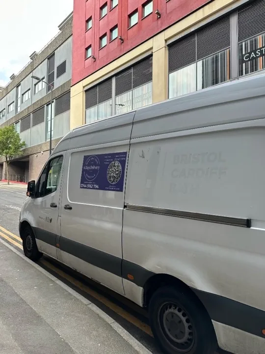 Student moves — branded van in city centre 6 Days Logistics branded removals van parked on a city street advertising student moves, man and van, and packing services