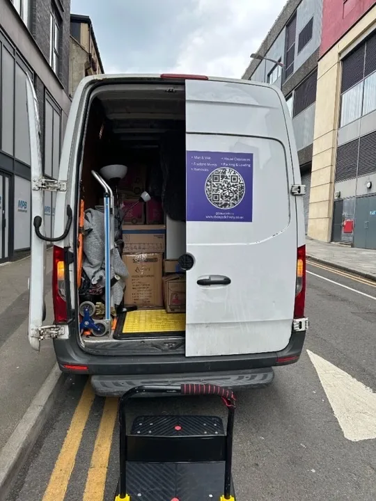 Student moves — van loaded with boxes and lamp Student move van loaded with cardboard boxes, a floor lamp, and moving blankets ready for a UK university relocation