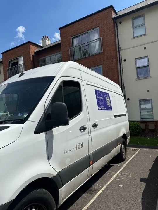 Student moves — van at residential building Removals van parked outside a modern residential building for a student house or flat move in Bristol, Cardiff, or Bath